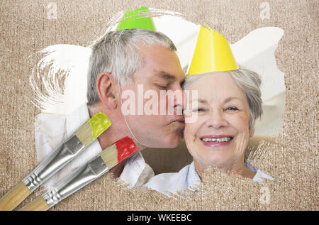 Image composite du couple celebrating birthday avec le pinceau imbibé de rouge contre la surface altérée Banque D'Images