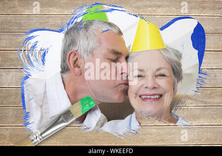 Image composite du couple celebrating birthday un pinceau trempé dans du vert contre surface en bois avec des planches Banque D'Images