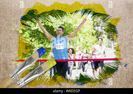 Image composite de racer crossing ligne d'arrivée avec le pinceau trempé dans le jaune contre la surface altérée Banque D'Images