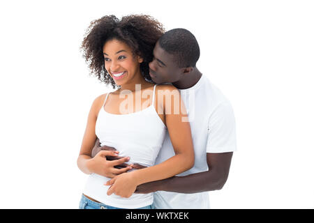 Casual couple embracing in tops blanc sur fond blanc Banque D'Images