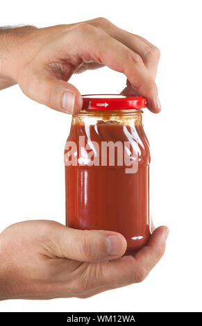 La pâte de tomate en pot part isolé sur fond blanc Banque D'Images