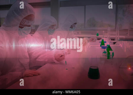 Trois pharmaciens travaillant dans des vêtements protecteurs contre ligne ecg en rouge et noir Banque D'Images