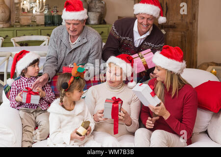 Famille heureuse l'échange de cadeaux de Noël à la maison dans le salon Banque D'Images