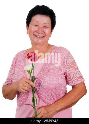 Happy Senior Asian Woman with carnation flower Banque D'Images