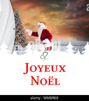 Image composite de santa tire quelque chose avec une carte de vœux de Noël à corde Banque D'Images