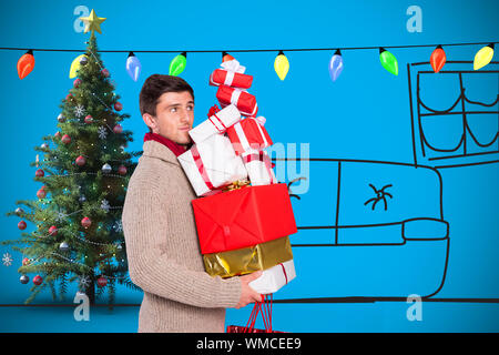 Jeune homme avec de nombreux cadeaux de noël contre fond bleu avec vignette