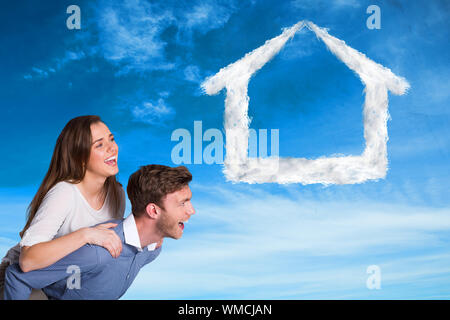 Portrait of young man carrying woman against blue sky Banque D'Images