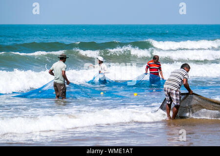 Les pêcheurs indiens avec des filets sur une plage à l'État du Maharashtra, Inde Banque D'Images