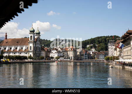 Vue depuis le pont de la chapelle vers l'église jésuite, le pont piétonnier Rathaussteg et la rivière Reuss à Lucerne, en Suisse. Banque D'Images