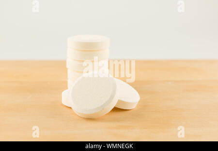 Très grand tour comprimés blancs sur un fond de bois Banque D'Images