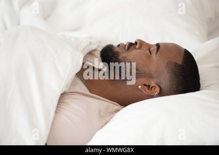 Close up young black man sleeping in bed. Banque D'Images