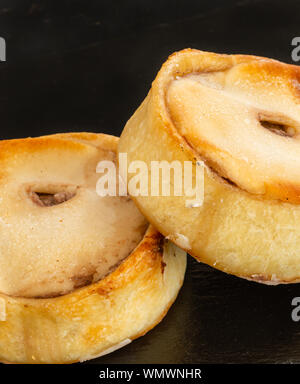 Deux Scotch pies juste du four et servie sur une assiette de service en ardoise noire. Banque D'Images