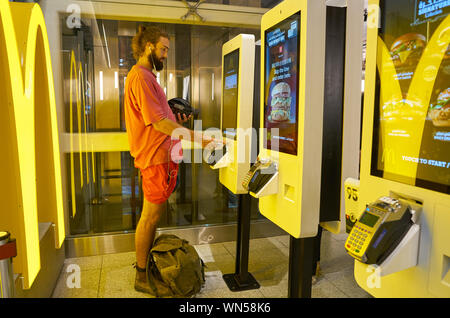 Dubaï, Émirats arabes unis - circa 2019, février : Utiliser des bornes de commande restaurant McDonald à l'Aéroport International de Dubaï. Banque D'Images