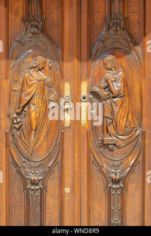 Côme, Italie - 8 mai 2015 : l'Annonciation de secours en bois sculpté sur la porte de sacristie à l'église sanctuaire del Santissimo Crocifisso par Ezechiele Banque D'Images