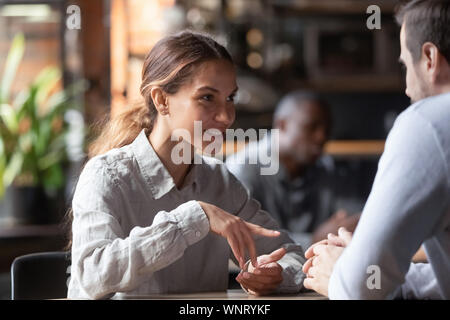 Mixed Race woman smiling attractive à discuter avec l'homme dans coffeehouse Banque D'Images