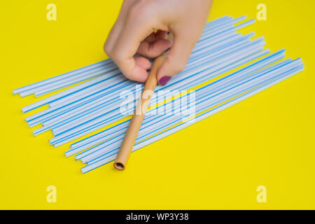 Le bambou paille pailles jetables vs sur un fond jaune. Concept Zéro déchet Banque D'Images