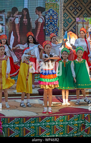 Boukhara, Ouzbékistan. Les enfants vêtus de costumes traditionnels ouzbek et russe, danse russe et de l'Ouzbek folk et chansons traditionnelles. Banque D'Images