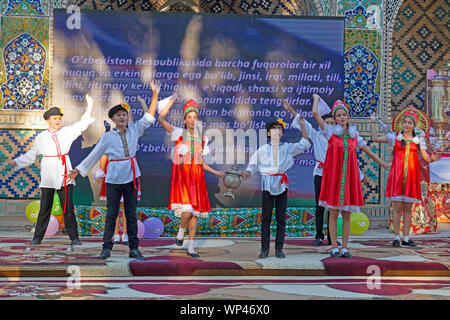 Boukhara, Ouzbékistan. Les enfants vêtus de costumes traditionnels ouzbek et russe, danse russe et de l'Ouzbek folk et chansons traditionnelles. Banque D'Images