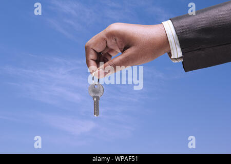 Businessman showing office key Stock Photo