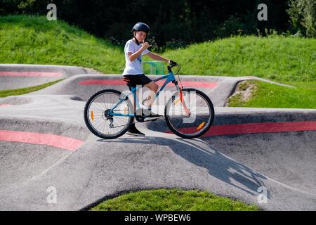 Enfant, garçon, 11 ans dans une ambiance poser sur un vélo de montagne en une pompe piste, vélo de montagne, sentier Viehhausen, Salzbourg, Autriche Banque D'Images