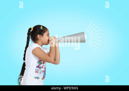 Girl shouting into a paper megaphone Stock Photo