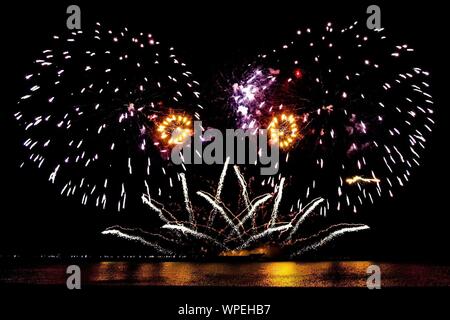 D'artifice en forme de coeur dans la nuit