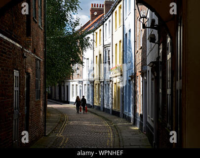 Deux jeunes femmes devant la maisons géorgiennes sur la rue Prince pavées, Hull, East Yorkshire, England UK Banque D'Images