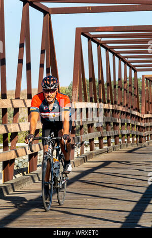 Huntington Beach, Californie / USA - Sept 10, 2019 : le cycliste traverse de passerelle au-dessus de la rivière de Santa Ana. Populaire auprès des coureurs, marcheurs et cyclistes chien. Banque D'Images