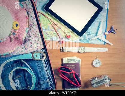 Ensemble d'accessoires de voyage dans les bagages de tablettes et des articles personnels sur fond de bois Banque D'Images