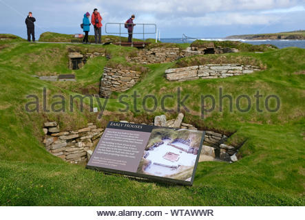 Les touristes visitant Skara Brae, un site néolithique en pierre, situé dans la partie continentale de l'Orkney, Ecosse Banque D'Images