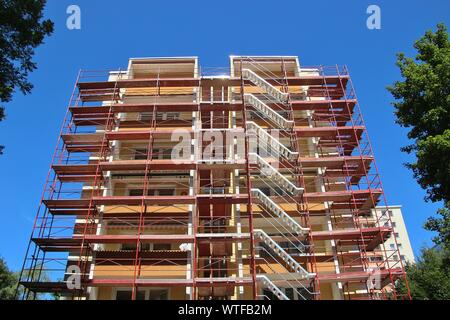 Rénovation sur la façade d'un immeuble d'appartements. Un échafaudage dans toute la maison. La ville de Salzbourg, Autriche, district de Lehen, l'Europe. Banque D'Images