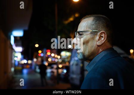 Berlin, Allemagne. 08Th Sep 2019. Peter-Christian Bürger, témoin contemporain et membre de la Bundesstiftung Aufarbeitung der dictature du SED, promenades à travers une rue dans le quartier berlinois de Friedrichshain après une journée de travail à la lumière d'un réverbère. Son visage est éclairé par un néon. (Dpa-Histoire : 30 Ans Prague Ambassade) Credit : Gregor Fischer/dpa/Alamy Live News Banque D'Images