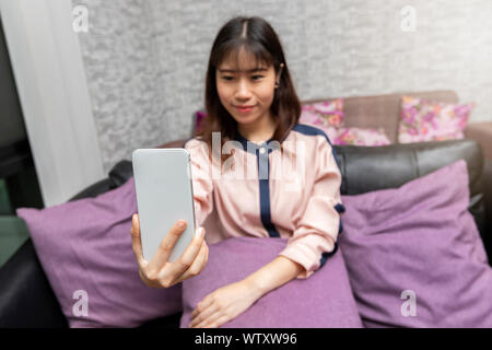 Close up young Asian businesswoman prenant photo selfies avec son téléphone mobile. Banque D'Images