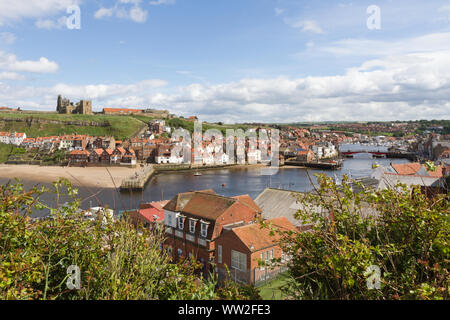 Whitby, North Yorkshire, Royaume-Uni : en regardant vers l'est depuis West Cliff, au-dessus de la rivière Esk et du port. St Mary et les ruines de l'abbaye se trouvent sur la falaise opposée. Banque D'Images