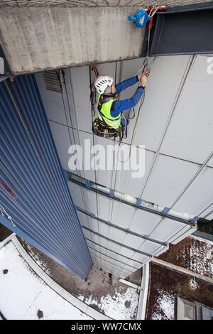 Grimpeur escalade la façade de la tour de chirurgie clinique d'Innsbruck, Tyrol, Autriche Banque D'Images