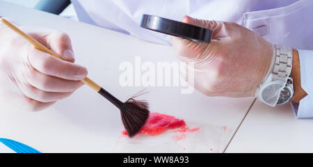 La criminologue chemist looking at police preuve du crime Banque D'Images