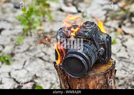 L'incendie a fondu et calcinés de l'appareil photo, caméra brûlées ne fonctionne pas. La mauvaise chance pendant un voyage de camping. Feu de forêt a détruit la propriété des photographes, th Banque D'Images