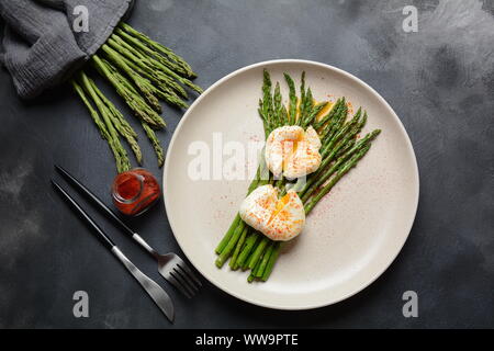 Asperges vertes avec œufs pochés sur une assiette. Concept de petit déjeuner sain Banque D'Images