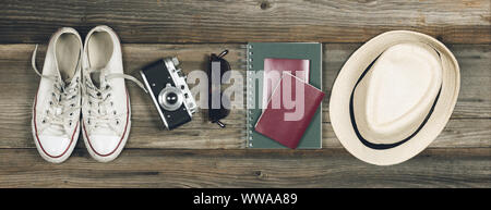 Essentials pour jeune personne moderne billet. Sneakers, appareil photo, lunettes, portable, passeport et un chapeau. Voyage facile Banque D'Images
