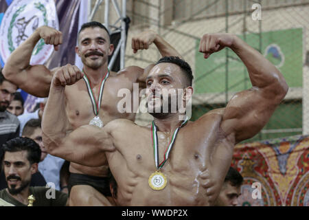 La ville de Gaza, Territoires palestiniens. 15 Sep, 2019. Les bodybuilders palestiniens célèbrent avec des médailles après la fin de la remise en forme et de musculation championnat. Credit : Mohammed Talatene/dpa/Alamy Live News Banque D'Images