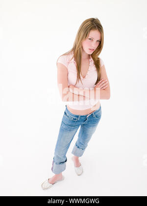 Teenage girl with arms crossed froncer Banque D'Images