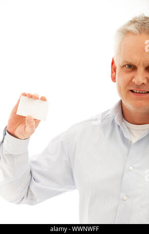 Homme d'âge moyen en chemise holding up a blank business card isolated on white Banque D'Images