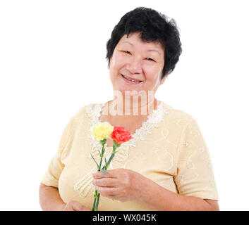 Happy Senior Asian Woman with carnation flower Banque D'Images