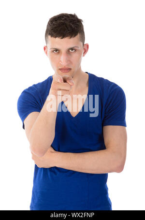 Jeune homme en colère pointant un doigt vers vous ; isolated on white Banque D'Images