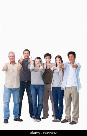 Smiling group giving Thumbs up against a white background Banque D'Images