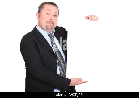 Man in suit holding white sign Banque D'Images