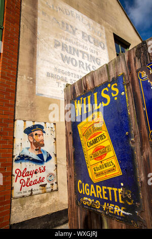 UK, County Durham, Beamish, musée, ville, rue Principale, l'émail publicité de cigarettes signes sur le mur de l'imprimante Banque D'Images