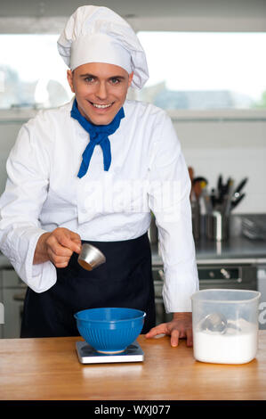 Cheerful male chef préparant un plat Banque D'Images