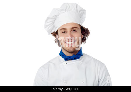 Young smiling male chef isolated over white Banque D'Images