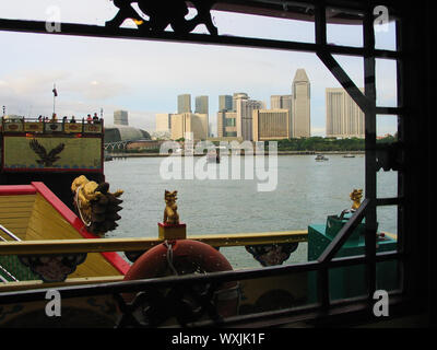Avec des dragons, sculpté, la ville est encadrée par la vue d'un croiseur de plaisance dans le port. Singapour. 29/11/2004 Banque D'Images